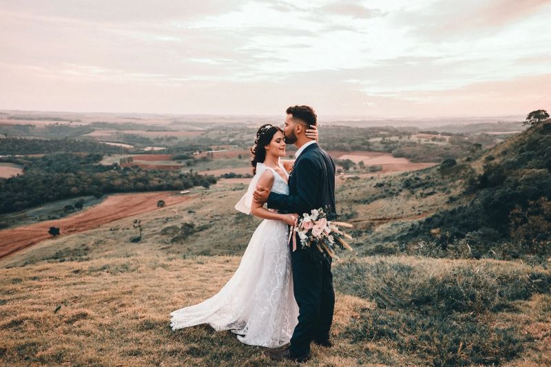 Bride and groom in fields