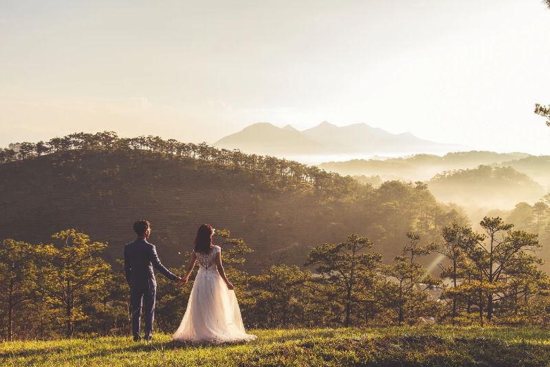 Bride and groom looking into mountains